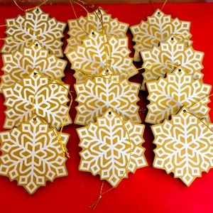 Set of 12 Gold and White wooden snowflake ornaments.